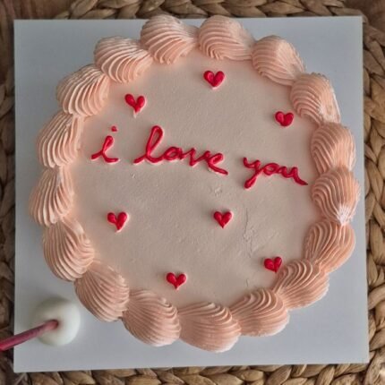 A beautifully decorated cake with 'I love you' text and heart accents. Perfect for romantic occasions.
