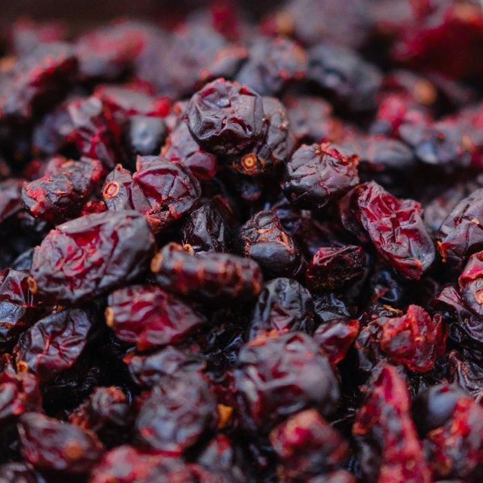 Detailed macro image of dried cranberries showcasing their rich texture and color for culinary use.