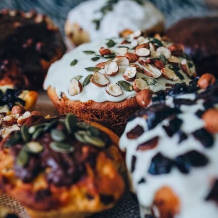 Close-up view of freshly baked muffins with assorted toppings and glaze, perfect for food lovers.